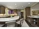 A spacious kitchen with wooden cabinets, granite countertops, an island with seating, and stainless steel appliances at 21 Wedgewood Rd, Chapel Hill, NC 27514