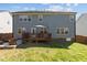 Large backyard with deck, umbrella, seating area and well-maintained lawn at 2220 Rainy Lake St, Wake Forest, NC 27587