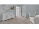 Bedroom featuring a changing table, chair, and view of the hall at 2220 Rainy Lake St, Wake Forest, NC 27587