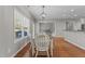 Cozy dining area with hardwood floors and a modern lighting fixture with backyard views at 2220 Rainy Lake St, Wake Forest, NC 27587