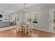 Bright dining area with a view of the living room, featuring hardwood floors and a modern light fixture at 2220 Rainy Lake St, Wake Forest, NC 27587
