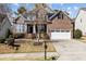 Charming two-story brick home with a well-manicured lawn and a two-car garage in a sunny neighborhood at 2220 Rainy Lake St, Wake Forest, NC 27587