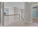 Upstairs hallway features neutral walls, carpet, and railing leading to bedrooms and bathrooms at 2220 Rainy Lake St, Wake Forest, NC 27587