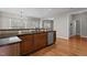 Kitchen island with granite countertops, wooden cabinetry and hardwood flooring at 2220 Rainy Lake St, Wake Forest, NC 27587