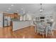 Open concept kitchen and living area with stainless steel appliances and hardwood floors at 2220 Rainy Lake St, Wake Forest, NC 27587