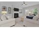 Bright living room with built-in shelves, a fireplace, and large windows that offer plenty of natural light at 2220 Rainy Lake St, Wake Forest, NC 27587