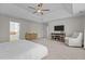 Spacious main bedroom featuring tray ceiling, ceiling fan, TV, and access to the main bath and walk-in closet at 2220 Rainy Lake St, Wake Forest, NC 27587