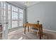 Bright home office with a wooden desk and large windows offering plenty of natural light at 2220 Rainy Lake St, Wake Forest, NC 27587