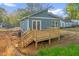 New backyard deck with stairs and blue vinyl siding at 230 N Melville St, Graham, NC 27253