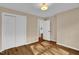 Bedroom with hardwood floors; bright with natural light from a large window at 230 N Melville St, Graham, NC 27253