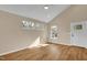 Bright room with vaulted ceiling, stylish flooring, and natural light from multiple windows at 230 N Melville St, Graham, NC 27253