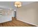 Open dining area with stainless steel refrigerator and hardwood floors; a modern eat-in-kitchen at 230 N Melville St, Graham, NC 27253