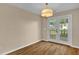 Dining area with hardwood floors and patio access through double doors to the outdoor deck at 230 N Melville St, Graham, NC 27253