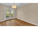 Bright dining area with stylish flooring and natural light from glass doors leading to the deck at 230 N Melville St, Graham, NC 27253