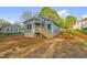 Exterior side view of blue house with new deck and steps at 230 N Melville St, Graham, NC 27253