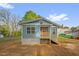 Charming blue home with a cozy front porch and freshly landscaped yard, providing curb appeal at 230 N Melville St, Graham, NC 27253