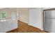 Modern kitchen area featuring stainless steel refrigerator, white cabinets, ample lighting and modern flooring at 230 N Melville St, Graham, NC 27253