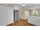 Stylish kitchen area featuring stainless steel refrigerator, white cabinets, ample lighting and modern flooring at 230 N Melville St, Graham, NC 27253