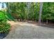 Lush backyard featuring mature plantings, grass, and wooded privacy at 2739 Elderberry Ln, Apex, NC 27539