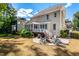 Spacious backyard features a fire pit, patio, lush landscaping, and a covered porch at 2739 Elderberry Ln, Apex, NC 27539