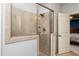 Tiled stand up shower with glass door located next to an open doorway to a bedroom at 2739 Elderberry Ln, Apex, NC 27539