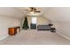 Large bonus room area featuring a bed, desk, dresser, and ceiling fan at 2739 Elderberry Ln, Apex, NC 27539