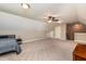 Spacious bonus room features neutral carpeting, ceiling fan, and plentiful natural light at 2739 Elderberry Ln, Apex, NC 27539
