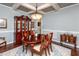Dining room featuring a wood table, six chairs, a china cabinet and coffered ceilings at 2739 Elderberry Ln, Apex, NC 27539