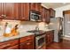 Well-appointed kitchen featuring granite counters, stainless steel appliances, and wooden cabinets at 2739 Elderberry Ln, Apex, NC 27539
