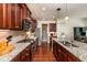 Bright kitchen featuring granite counters, stainless steel appliances and wooden cabinets at 2739 Elderberry Ln, Apex, NC 27539