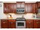 Kitchen featuring stainless steel appliances, granite counters and wood cabinets at 2739 Elderberry Ln, Apex, NC 27539
