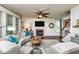 A spacious living room with fireplace, large windows, and comfortable seating at 2739 Elderberry Ln, Apex, NC 27539
