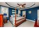 Spacious main bedroom with tray ceilings, a four-poster bed, and natural light at 2739 Elderberry Ln, Apex, NC 27539