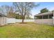 Well-maintained backyard with white fence, green grass and views of the home's sunroom at 2782 N Shiloh Rd, Garner, NC 27529