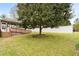 Spacious backyard featuring a deck, large tree, and a white privacy fence at 2782 N Shiloh Rd, Garner, NC 27529