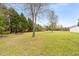 Large backyard surrounded by mature trees and foliage offering privacy and space for outdoor activities at 2782 N Shiloh Rd, Garner, NC 27529