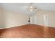 Large bedroom with hardwood floors, a ceiling fan, and access to other rooms at 2782 N Shiloh Rd, Garner, NC 27529