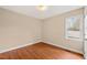 Bedroom showcasing wood-look floors, neutral walls, and a sunlit window at 2782 N Shiloh Rd, Garner, NC 27529
