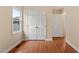 Bedroom featuring wood-look floors, a window, and a double-door closet at 2782 N Shiloh Rd, Garner, NC 27529