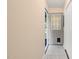 Neutral hallway with an open door, tile floor, and access to a closet at 2782 N Shiloh Rd, Garner, NC 27529