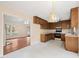 Open kitchen with wood cabinets and an opening that leads into the living room at 2782 N Shiloh Rd, Garner, NC 27529