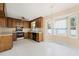 Eat-in kitchen area surrounded by wood cabinets and natural light, with fan at 2782 N Shiloh Rd, Garner, NC 27529