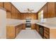 Traditional kitchen with wood cabinets, white countertops, and standard appliances at 2782 N Shiloh Rd, Garner, NC 27529