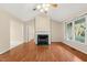 Bright living room featuring a fireplace, ceiling fan, and wood-look floors at 2782 N Shiloh Rd, Garner, NC 27529