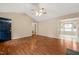 Open-concept living room with wood flooring and a glimpse into other rooms at 2782 N Shiloh Rd, Garner, NC 27529