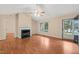 Spacious living room with a cozy fireplace, ceiling fan, and natural light at 2782 N Shiloh Rd, Garner, NC 27529