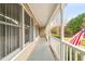 View of the covered side porch featuring white columns and railing at 2782 N Shiloh Rd, Garner, NC 27529