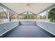 Enclosed sunroom with blue wainscoting, carpeted floor, and multiple windows at 2782 N Shiloh Rd, Garner, NC 27529