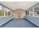 Enclosed sunroom featuring many windows and a ceiling fan at 2782 N Shiloh Rd, Garner, NC 27529