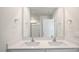 Bright bathroom featuring a double vanity with white countertops and a large mirror at 291 Hanging Elm Ln, Fuquay Varina, NC 27526